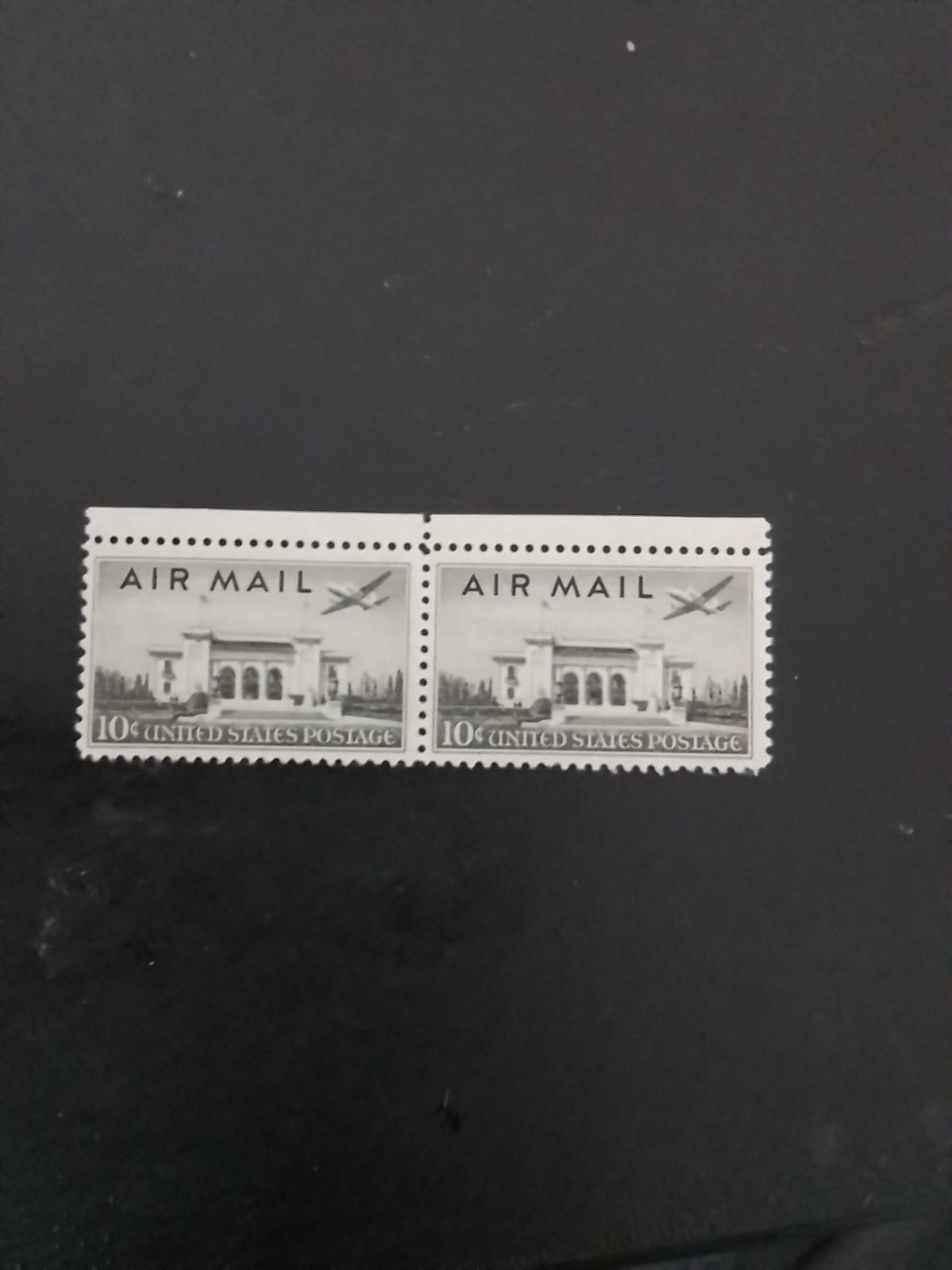Pair of two violet 10-cent US air mail stamps featuring the Pan-American Union building and an airplane.