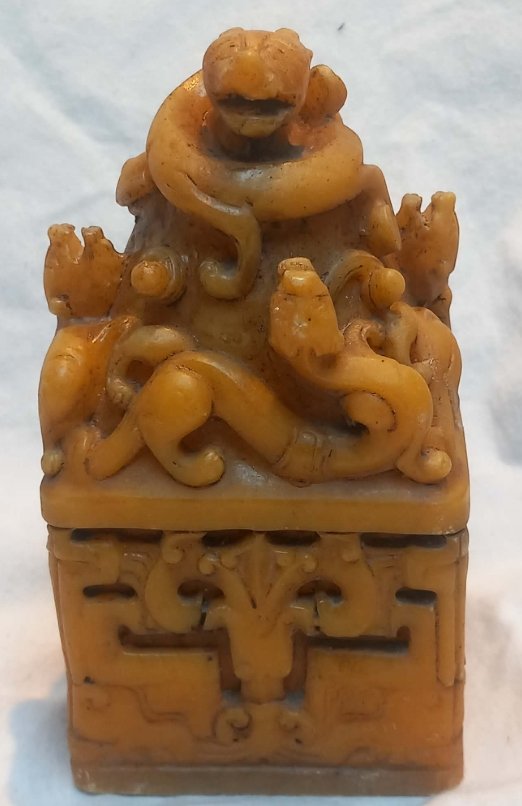 Carved yellow Shoushan stone Chinese seal blank featuring coiled dragons and archaic scrollwork, uncarved flat base - view 1