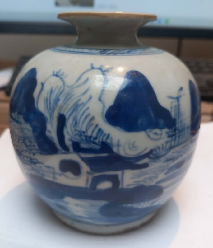 Small round Chinese blue and white porcelain jar painted with a traditional mountain and landscape scene. - view 1