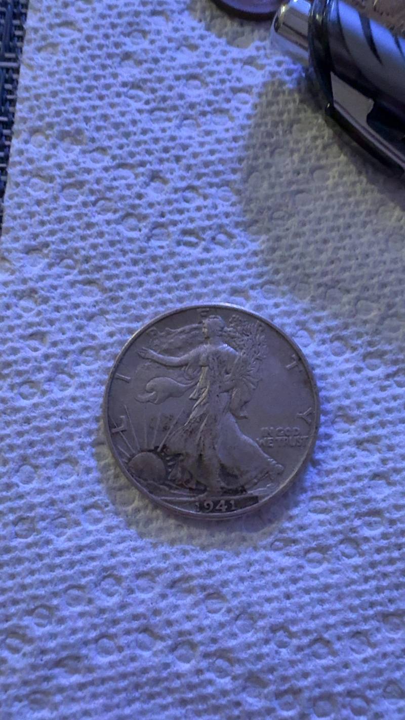 Obverse and reverse views of a 1941 Walking Liberty silver half dollar showing circulated wear and dark toning. - view 1