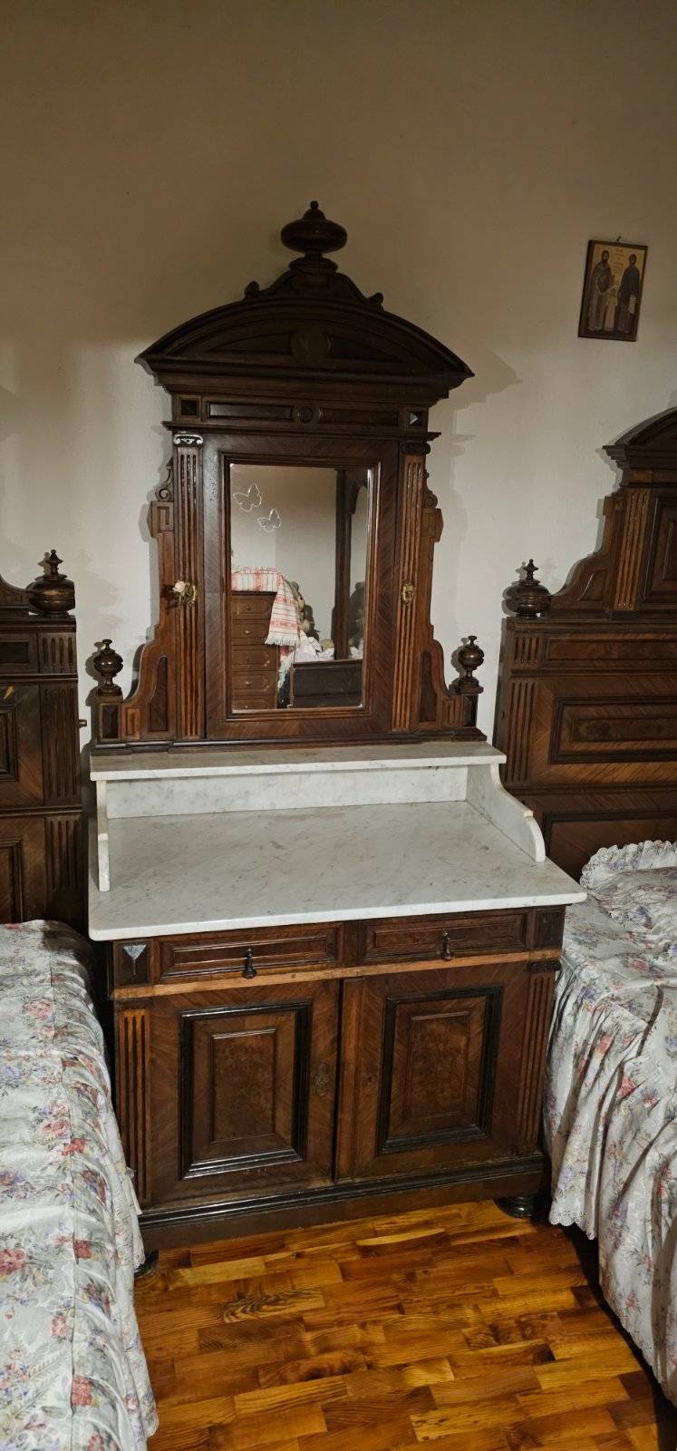 A late 19th-century Italian walnut bedroom suite including twin beds, a mirrored washstand with marble top, and a large mirrored armoire. - view 1
