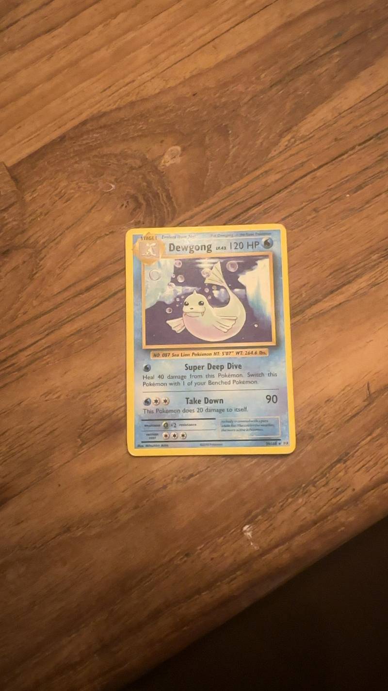 English language Pokémon TCG Dewgong card from the Aquapolis set (29/103) on a wooden surface.