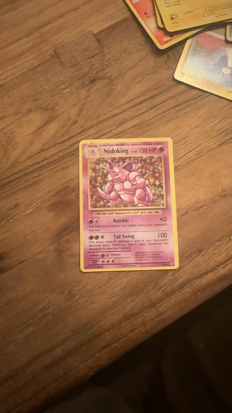 Nidoking Holo Rare Pokémon card from Base Set 2, featuring the pink Nidoking character on a starry background.