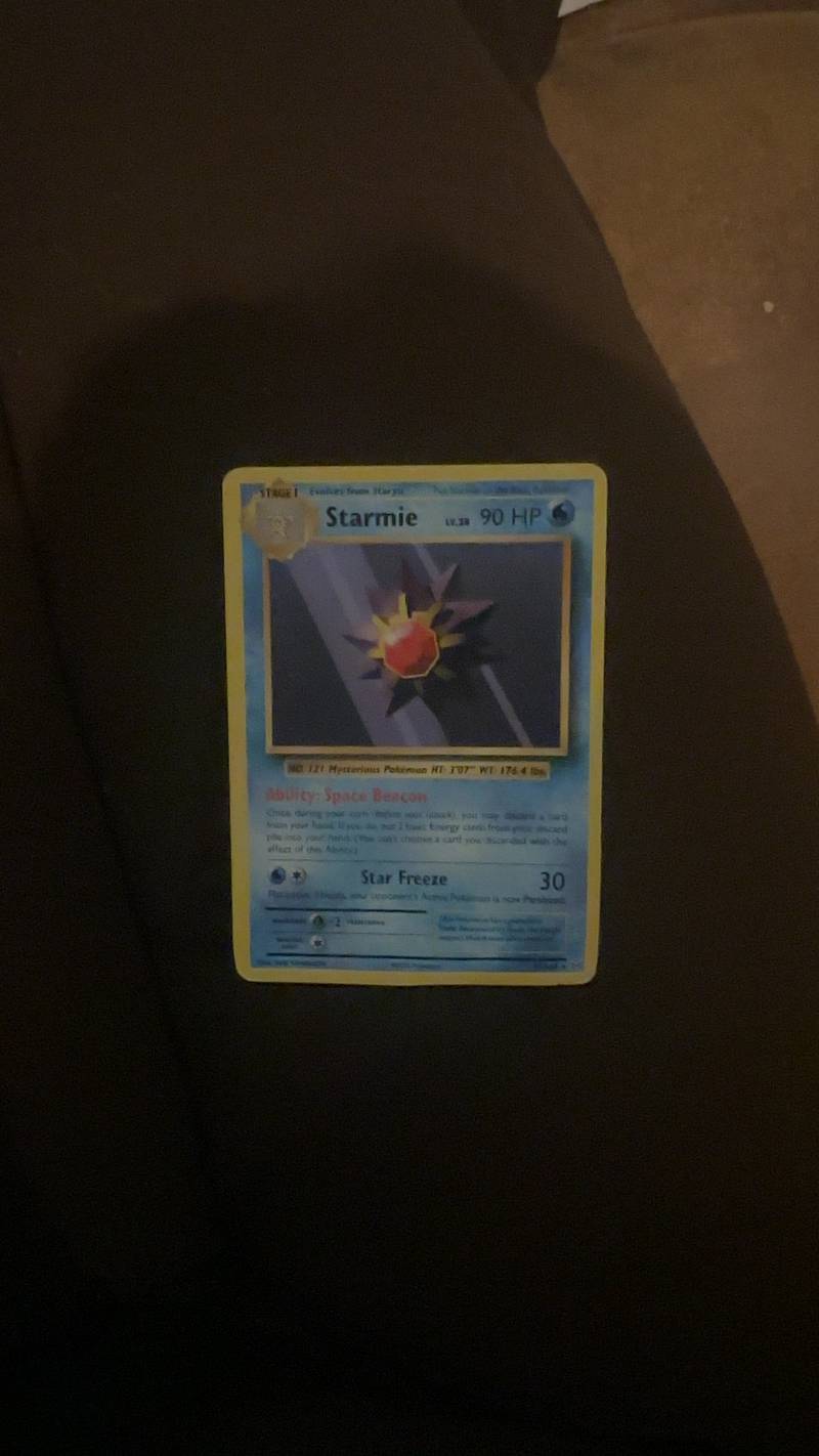 Holographic Pokémon Starmie card from the Neo Revelations set, featuring a starry background and the Pokémon's gem glowing.