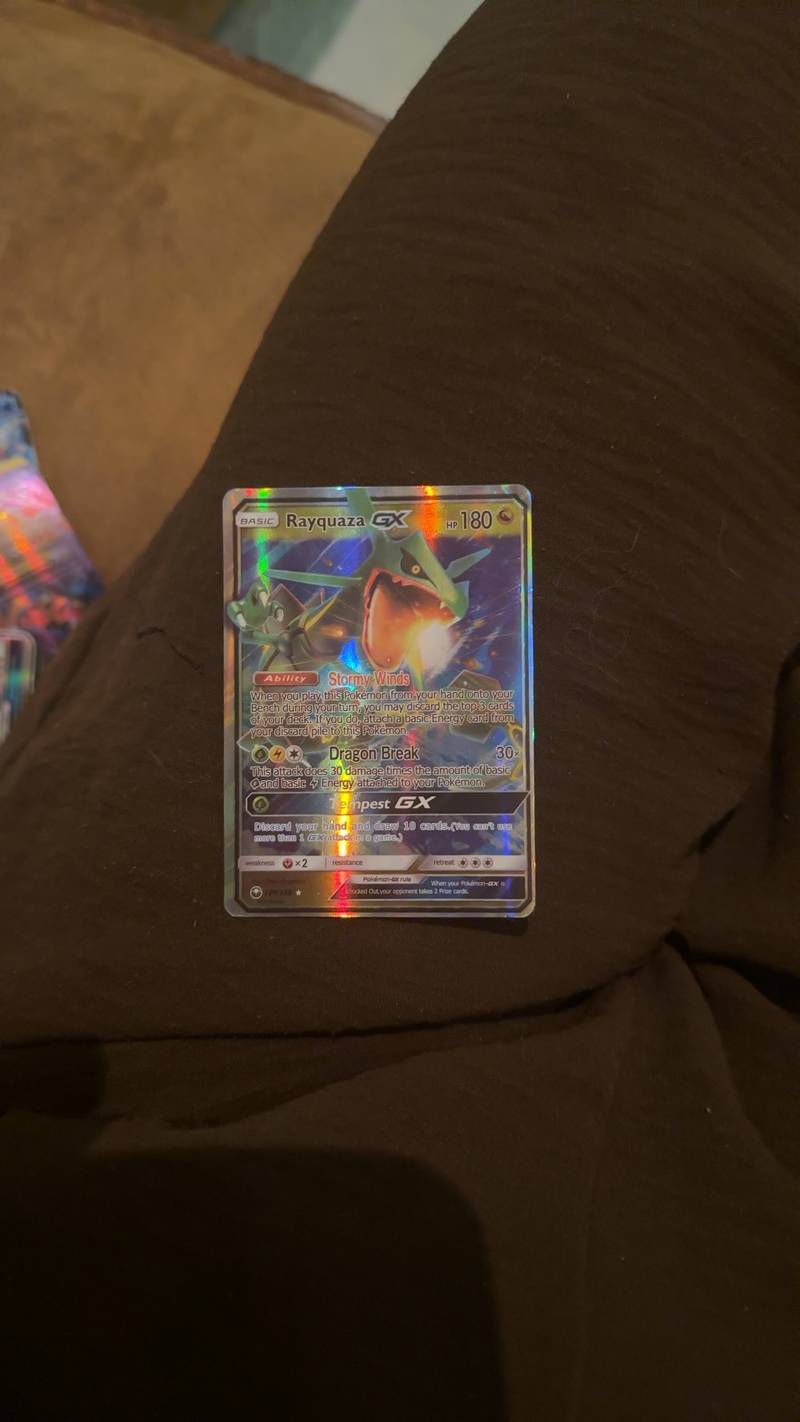 Close-up of a holographic Pokémon TCG Rayquaza-GX Rainbow Rare trading card from the Cosmic Eclipse expansion.