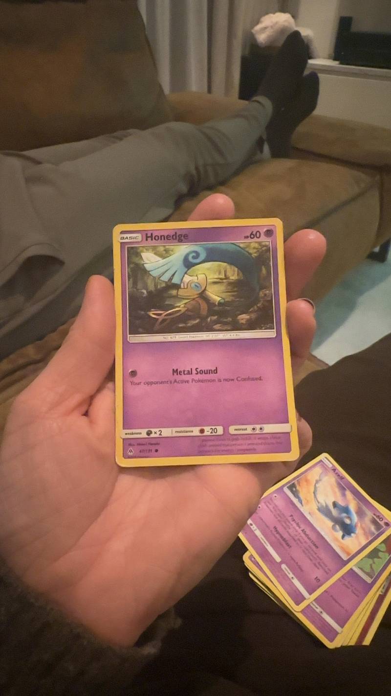 Honedge Pokémon card from the Forbidden Light set, Reverse Holo, held in a hand.