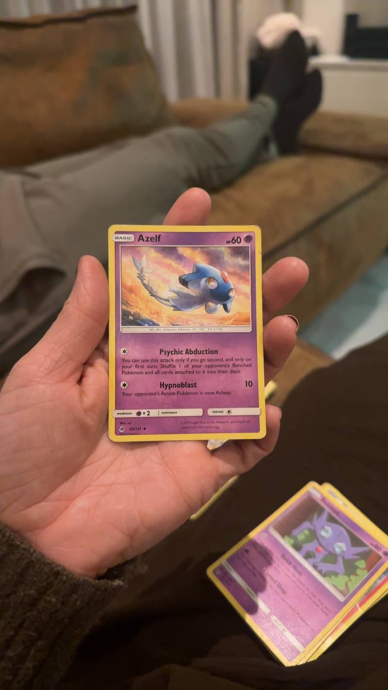 English Pokémon TCG Azelf Holo Rare card from Forbidden Light set, 43/131, held in a hand showing some edge wear.