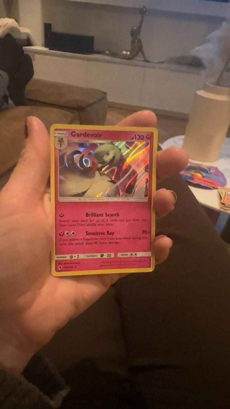 Close-up of a holographic Pokémon TCG Gardevoir card from the Sun & Moon Burning Shadows set, held in hand.