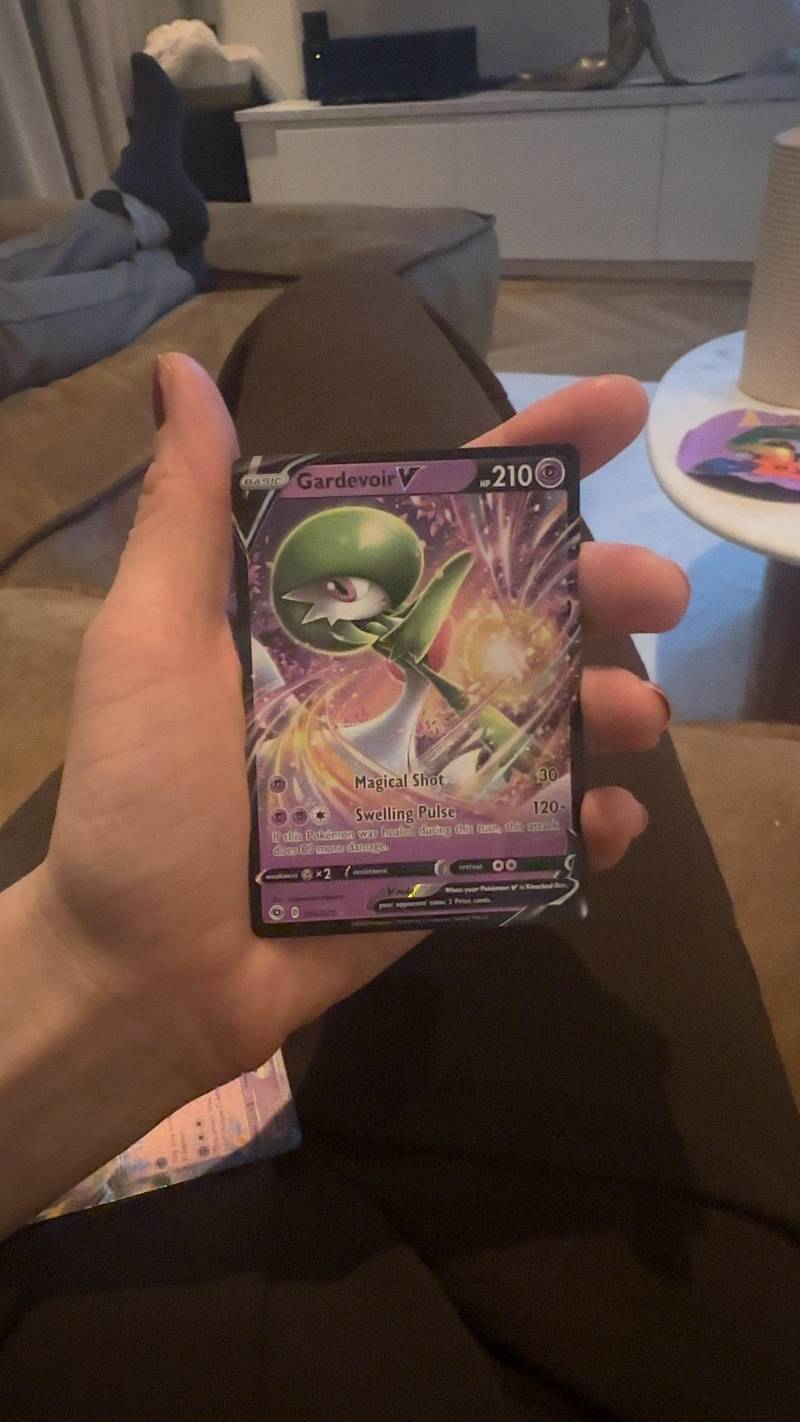 Close-up of a Gardevoir V holographic Pokémon trading card from the Chilling Reign set held in a hand.