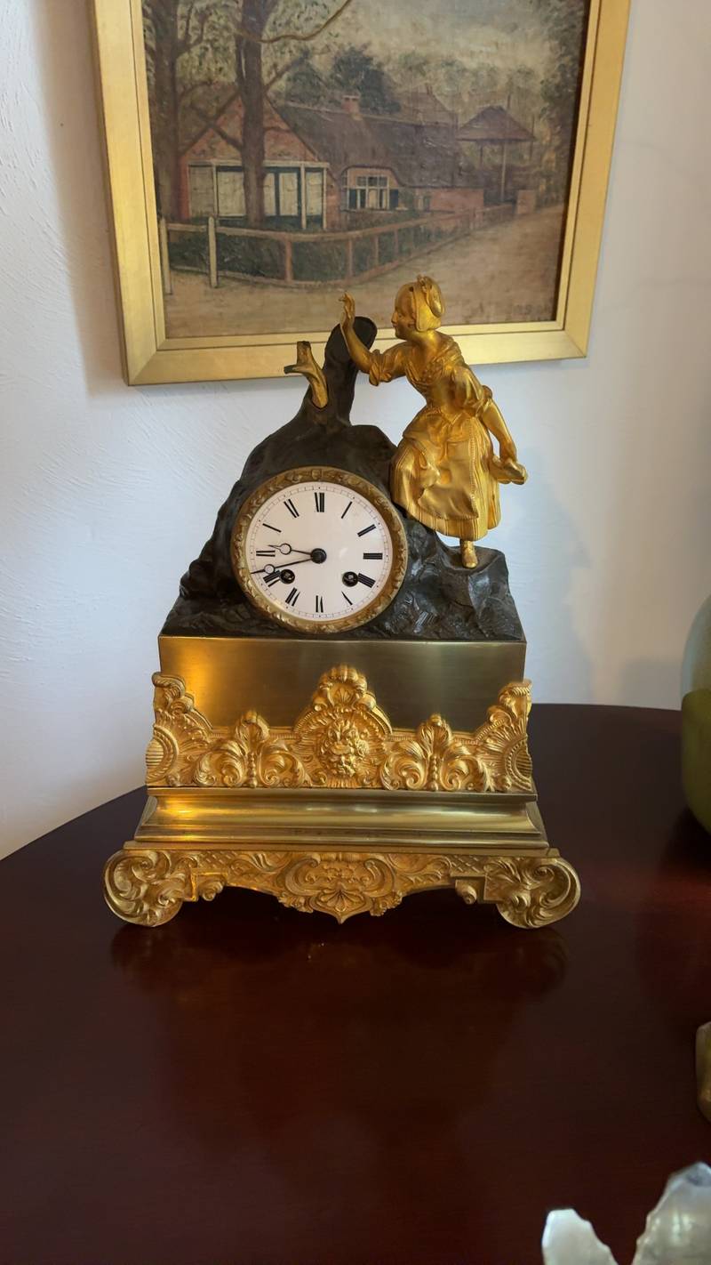 French gilt bronze and patinated spelter figural mantle clock with a young woman figure and ornate rococo base. - view 1