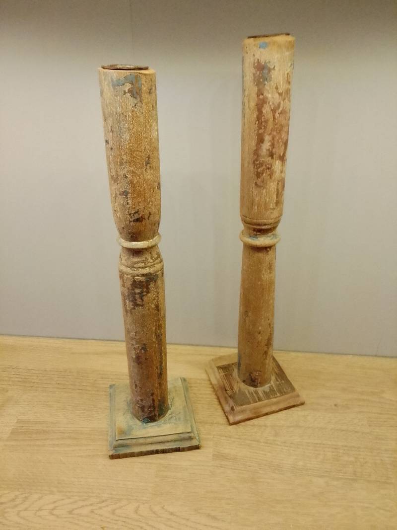 Pair of tall, distressed wooden candle holders with chipped blue and white paint and square bases. - view 1