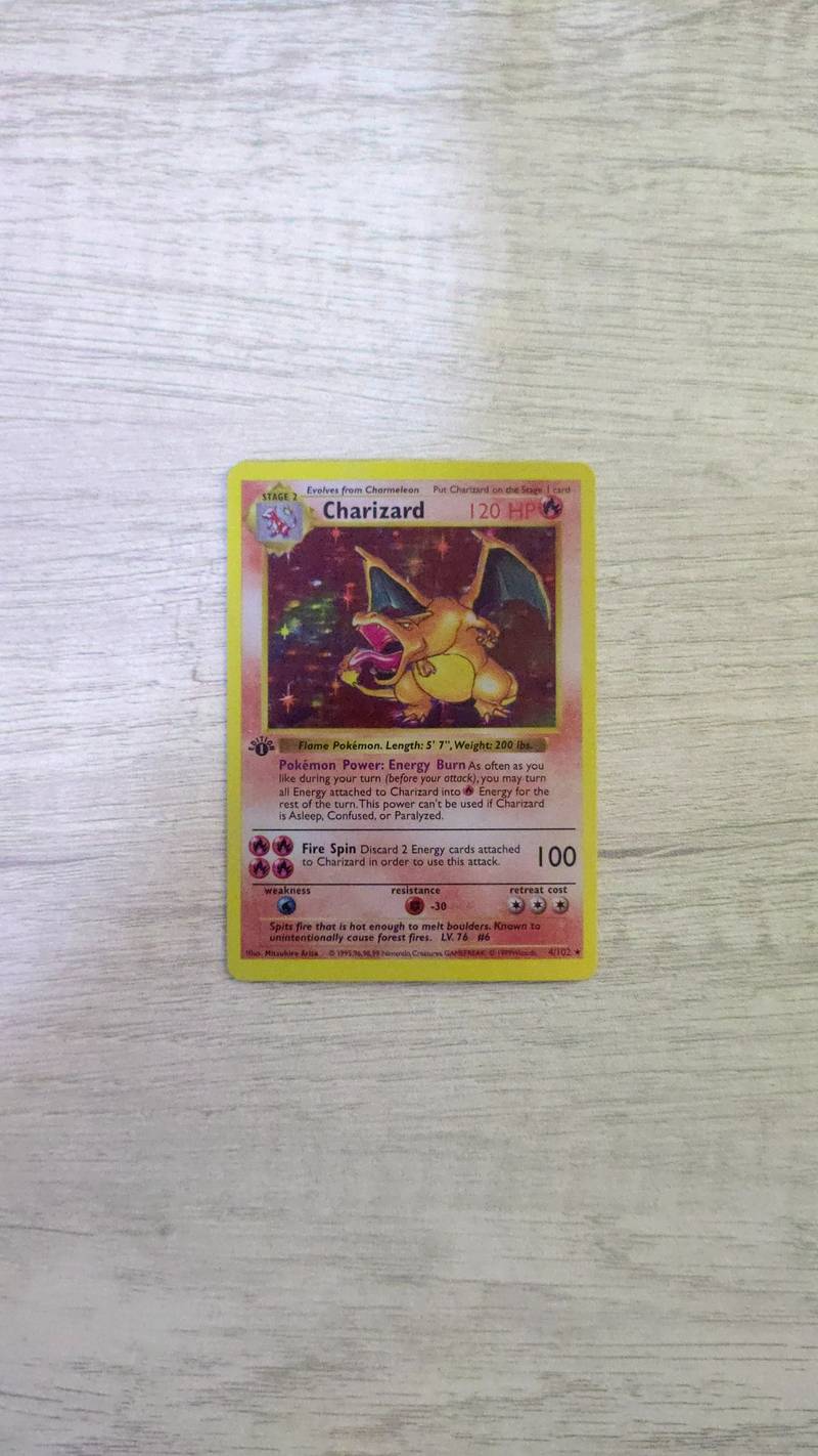 1999 Pokémon Base Set 1st Edition Shadowless Charizard holofoil card with starlight foil pattern. - view 1