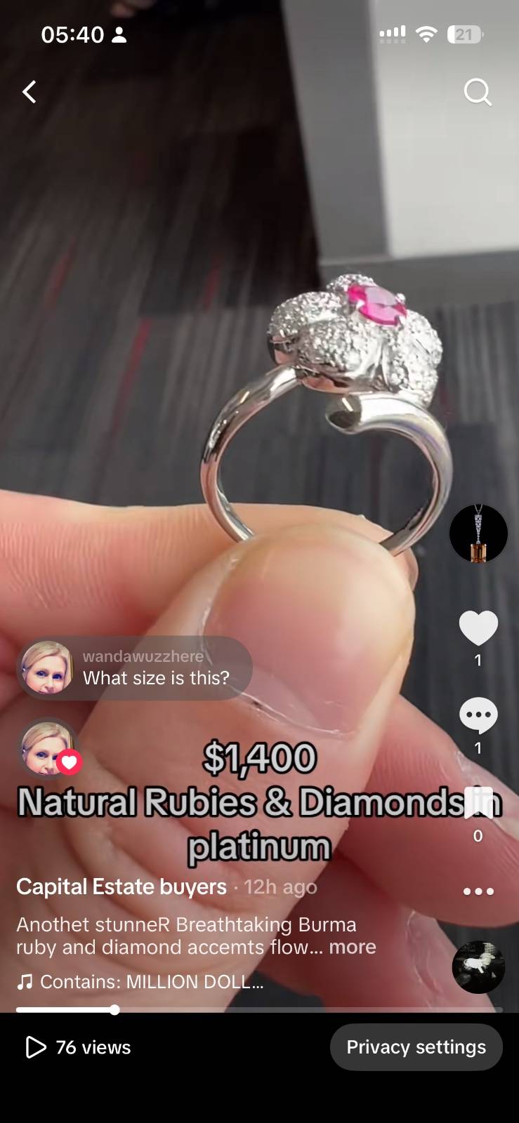 White metal bypass ring featuring a pavé diamond floral head centered with an oval ruby.