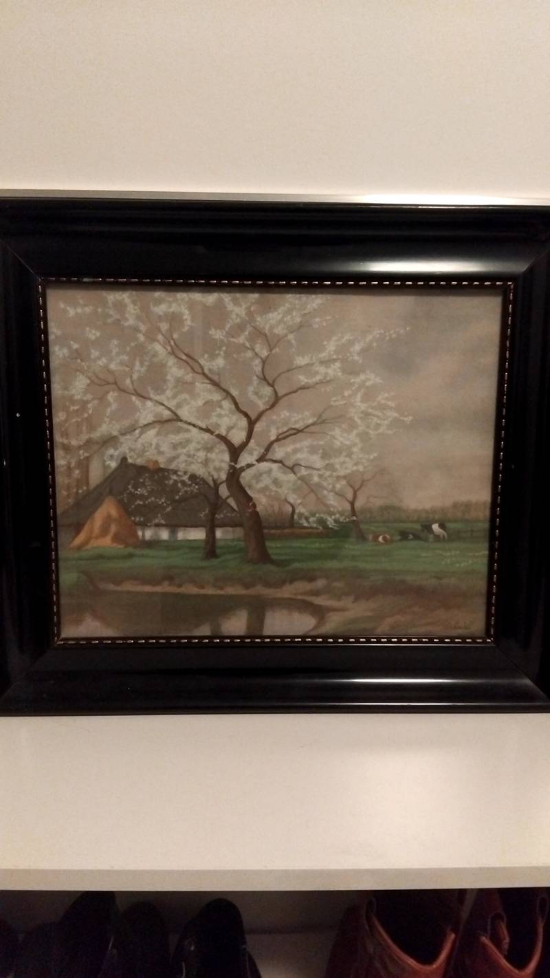 A pastel painting of a rural farm with a white flowering tree and cows under a cloudy sky, housed in a wide black frame. - view 1