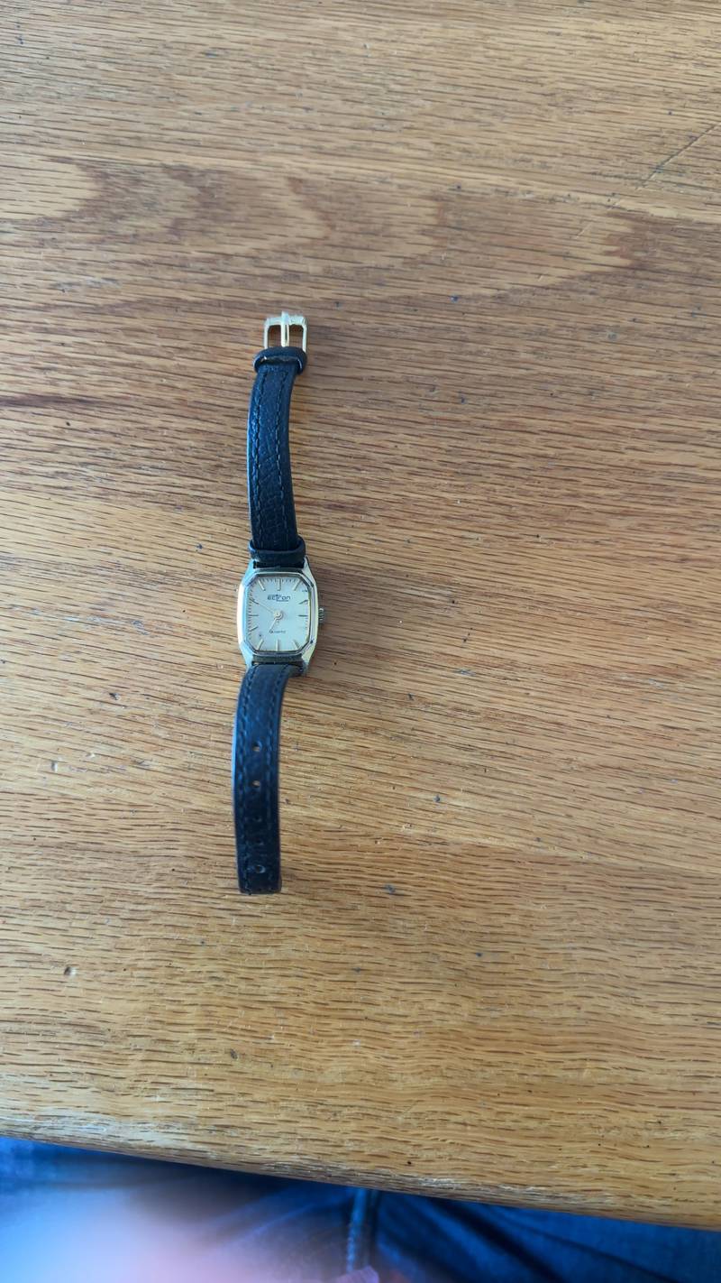 Vintage Ectron gold-tone ladies quartz watch with a black leather strap on a wooden surface. - view 1