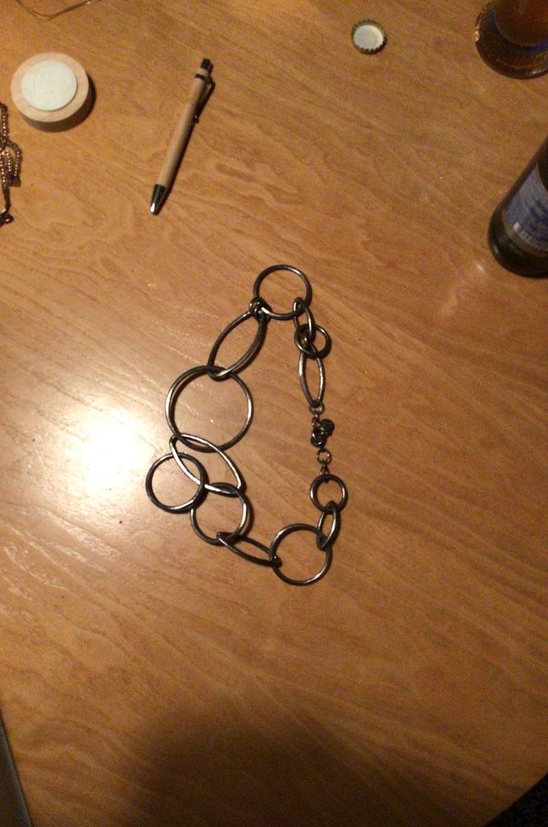 Contemporary dark metal link chain necklace featuring large circular and oval links.