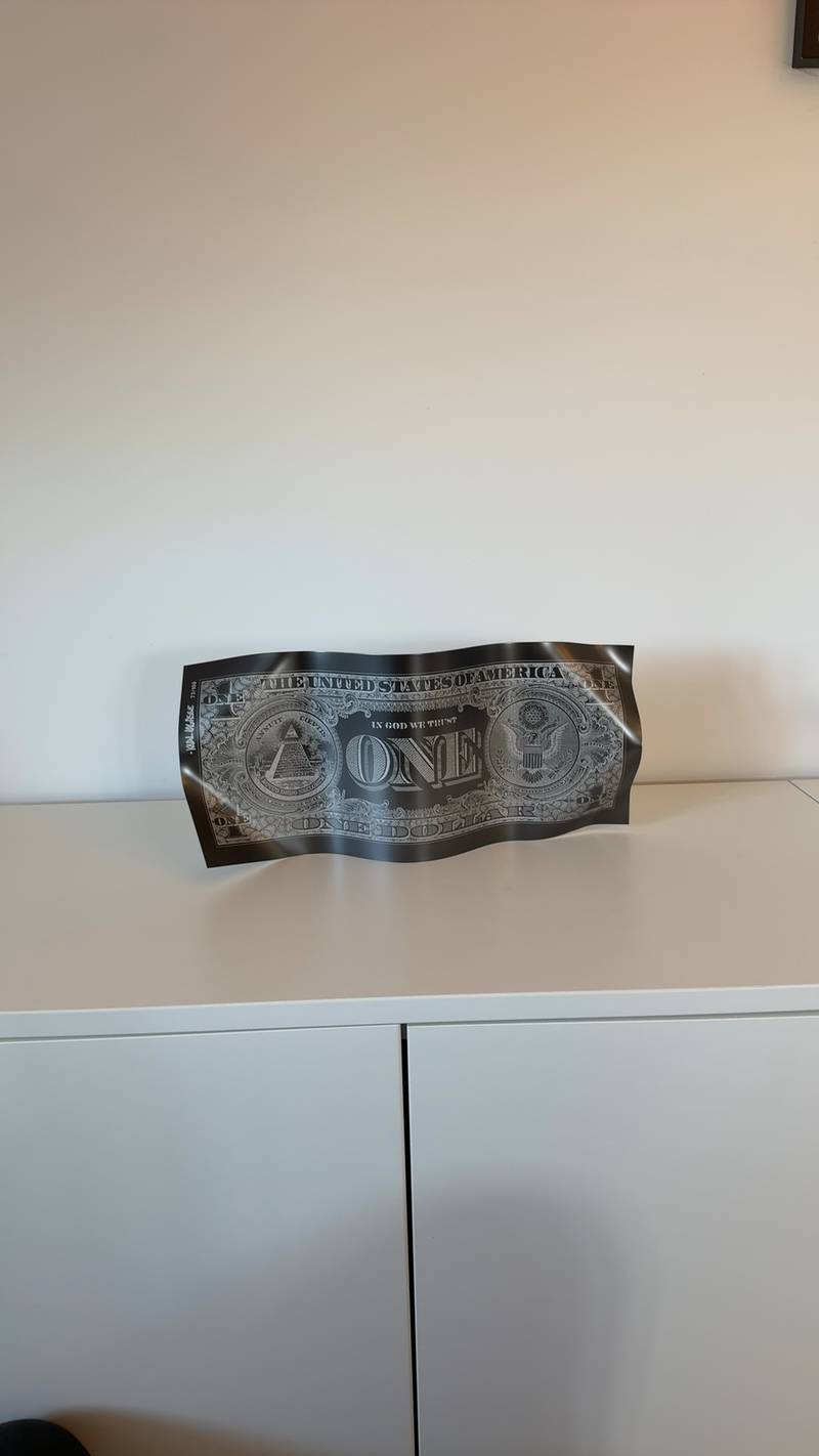 Scupltural one dollar bill by Karl Lagasse, matte black with silver printing, numbered 73/100 and signed by the artist. - view 1