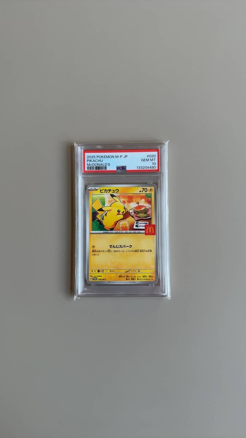PSA graded Japanese Pikachu McDonald's promotional Pokemon card, rated GEM MT 10, showing Pikachu eating a meal with a McDonald's 'M' logo. - view 1