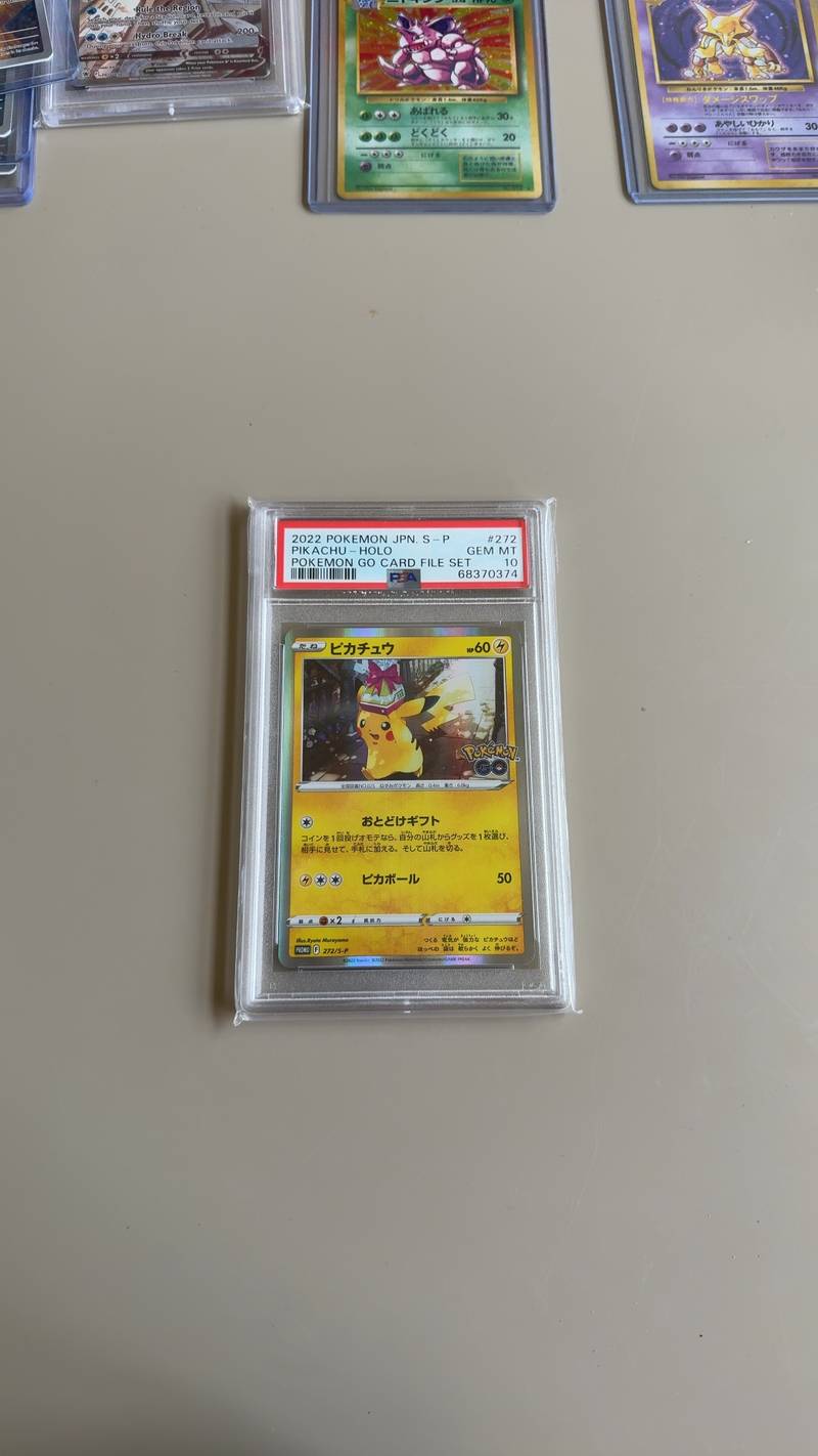 A PSA 10 graded Japanese Pikachu Pokémon GO promotional card, number 272/S-P, showing Pikachu carrying a gift. - view 1