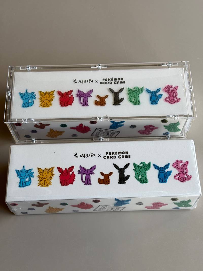 Two sealed Yu Nagaba x Pokemon Card Game Eevees Special Boxes, one in an acrylic display case. - view 1