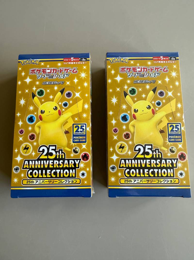 Two factory sealed Japanese Pokemon 25th Anniversary Collection booster boxes s8a showing front, top flap, and barcode panels - view 1