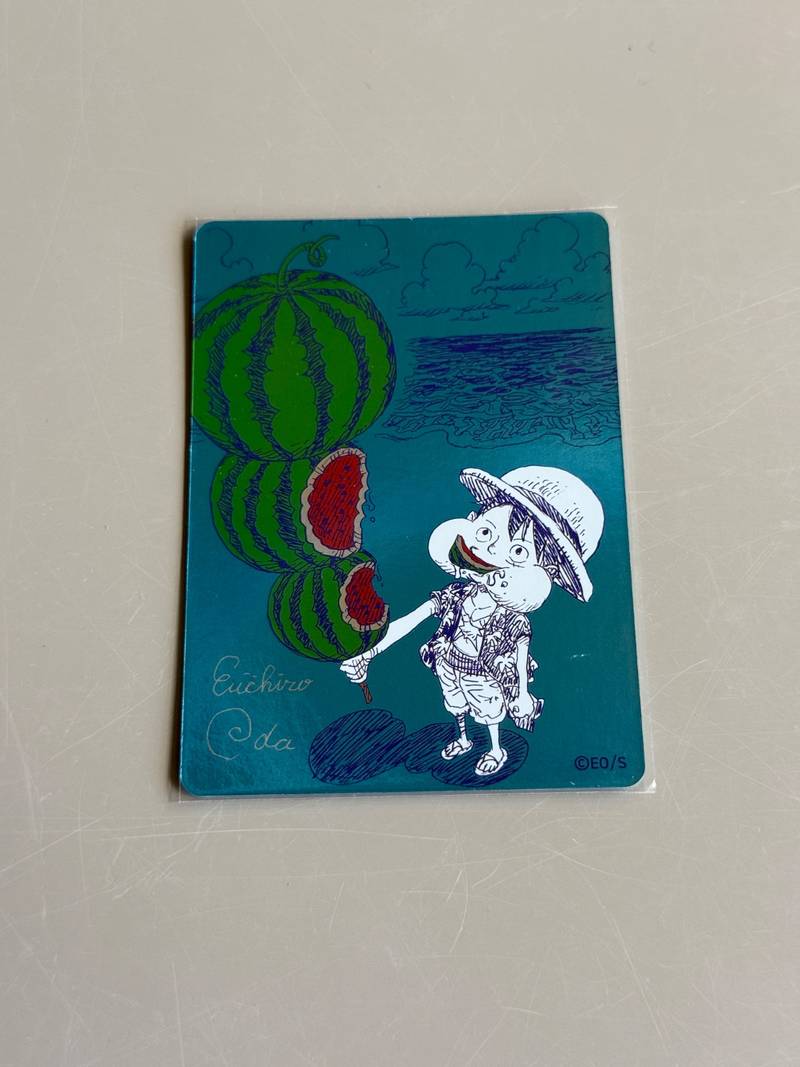 Front and back of a Japanese One Piece promotional card from Shueisha Natsucomi 2026 depicting Monkey D. Luffy with watermelons. - view 1