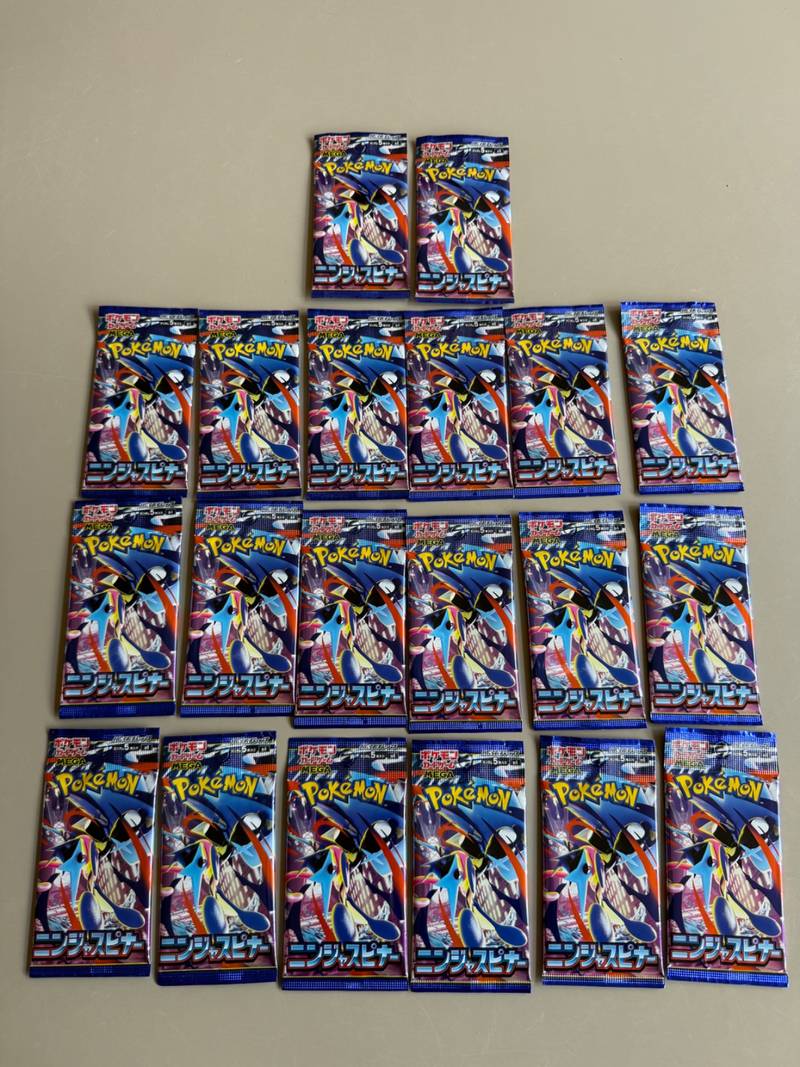 Twenty Japanese Pokémon TCG Ninja Spinner M4 booster packs arranged in rows showing front and back packaging - view 1