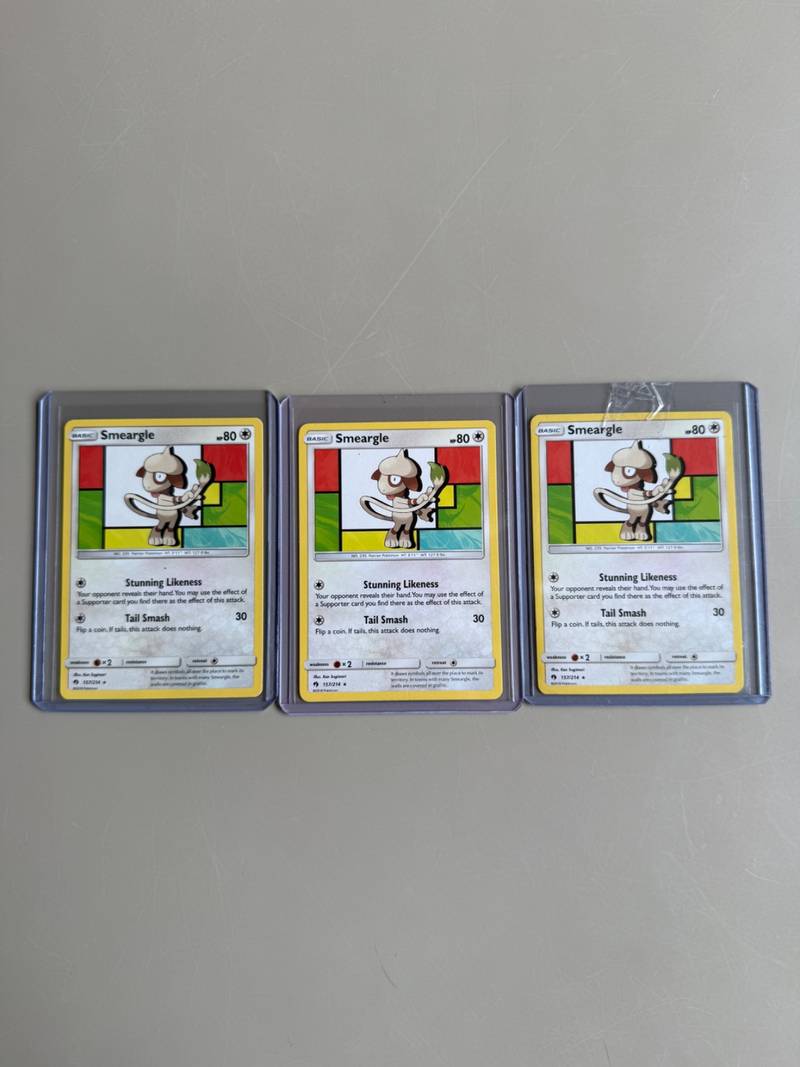 Three English Pokemon cards of Smeargle from the 2018 Lost Thunder set in rigid plastic toploaders - view 1